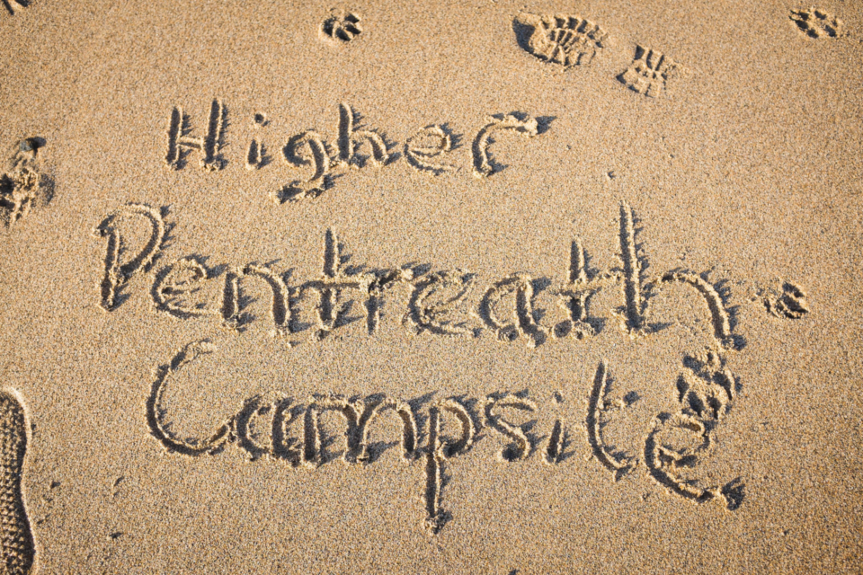 Writing our name "Higher Pentreath Campsite" in the golden sands of our nearest beach.